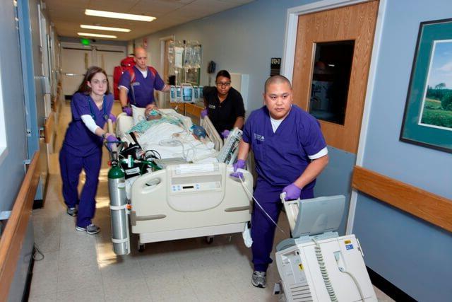 medical professionals transporting a trauma victim on a gurney